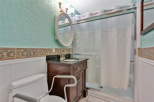 bathroom featuring tile patterned flooring, vanity, curtained shower, and toilet