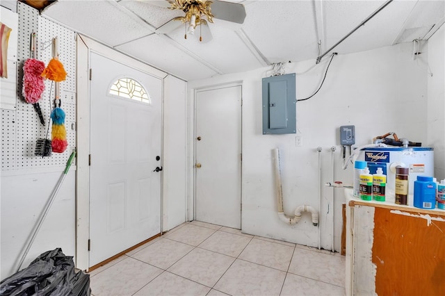 entrance foyer with a drop ceiling, light tile patterned floors, electric panel, and ceiling fan