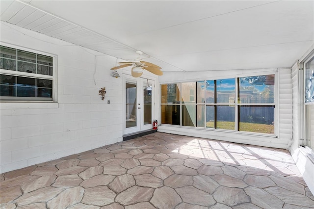 unfurnished sunroom with ceiling fan