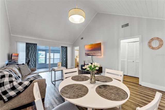 dining room with high vaulted ceiling, hardwood / wood-style floors, and wood ceiling