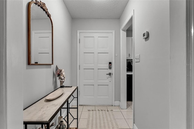 interior space featuring light tile patterned floors and a textured ceiling