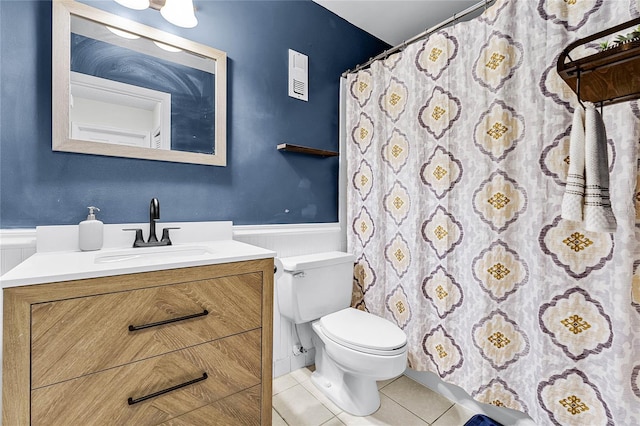 bathroom with toilet, tile patterned flooring, and vanity