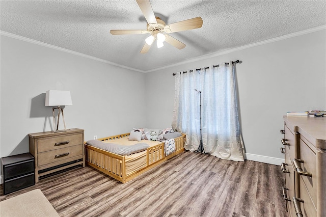 bedroom featuring crown molding, hardwood / wood-style floors, a textured ceiling, and ceiling fan