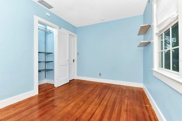 empty room featuring hardwood / wood-style flooring