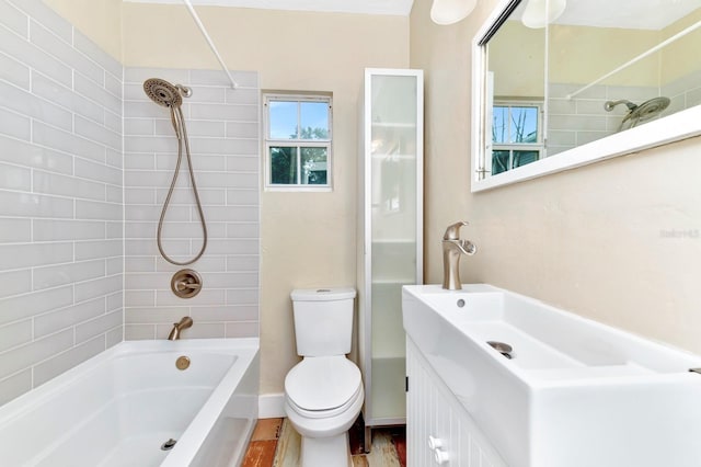 full bathroom with tiled shower / bath, vanity, toilet, and wood-type flooring