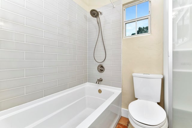 bathroom featuring wood-type flooring, toilet, and tiled shower / bath combo