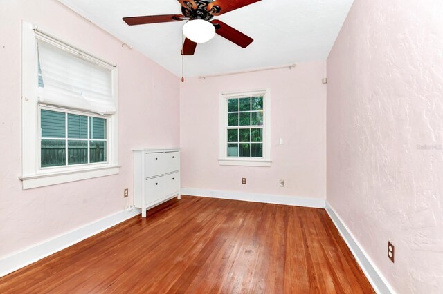 spare room featuring hardwood / wood-style flooring and ceiling fan