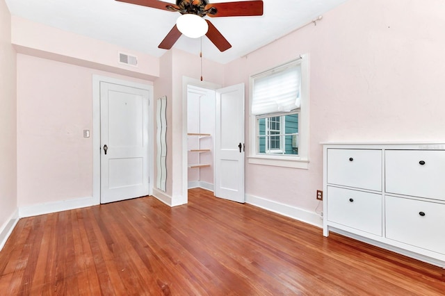 unfurnished bedroom featuring ceiling fan and wood-type flooring