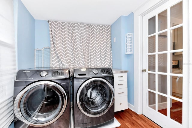 laundry room featuring hardwood / wood-style floors and washer and clothes dryer