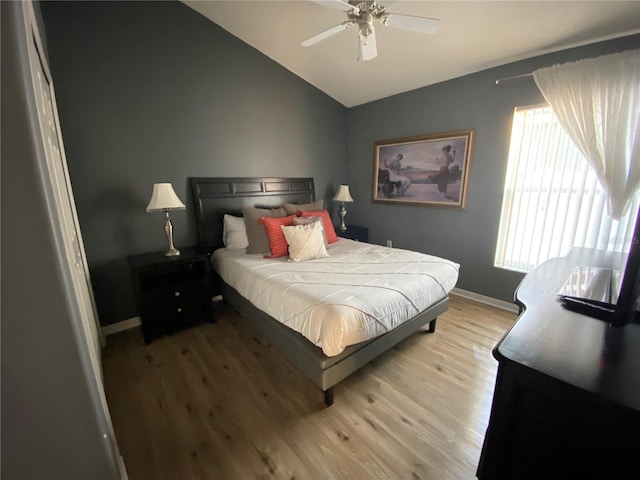 bedroom with lofted ceiling, light hardwood / wood-style flooring, and ceiling fan