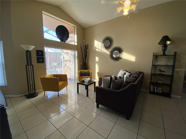 tiled living room featuring ceiling fan and lofted ceiling