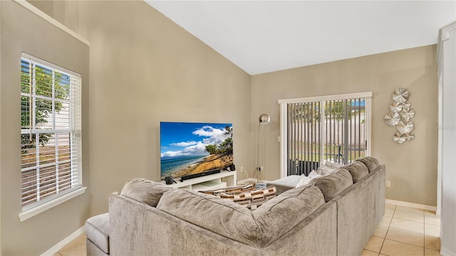 tiled living room featuring vaulted ceiling