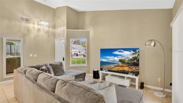 living room featuring high vaulted ceiling, plenty of natural light, and light tile patterned floors