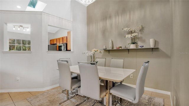 dining room with light tile patterned flooring and lofted ceiling