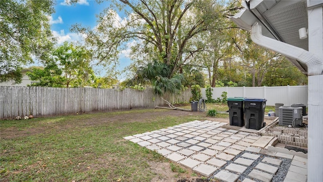 view of yard featuring central AC unit and a patio