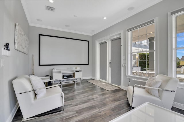 cinema room with hardwood / wood-style flooring and ornamental molding