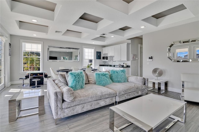 living room with coffered ceiling and light wood-type flooring