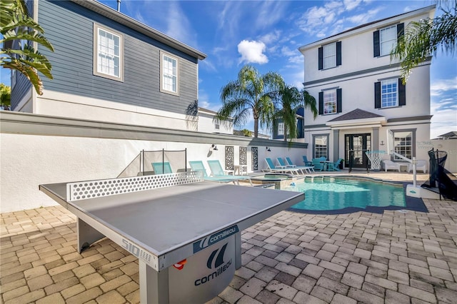 view of pool featuring an in ground hot tub and a patio area