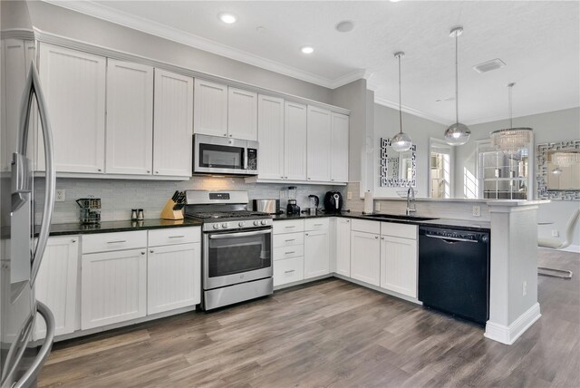 kitchen with sink, white cabinetry, decorative light fixtures, kitchen peninsula, and stainless steel appliances