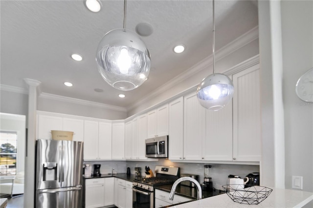 kitchen featuring white cabinetry, crown molding, hanging light fixtures, appliances with stainless steel finishes, and backsplash