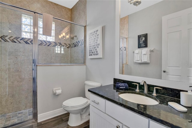 bathroom featuring hardwood / wood-style flooring, vanity, toilet, and an enclosed shower