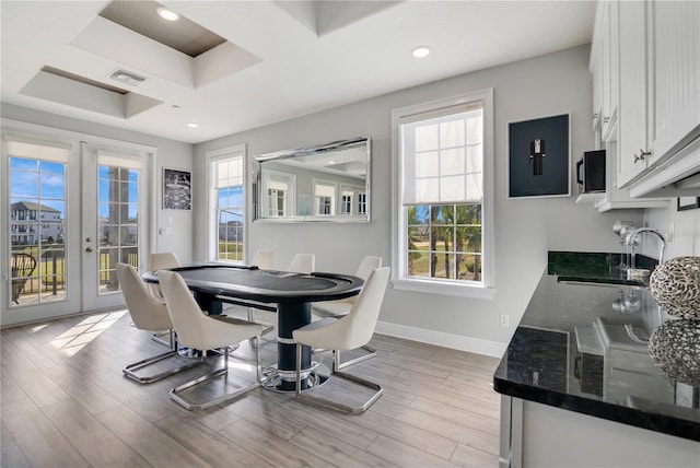 dining area featuring sink, light hardwood / wood-style floors, and french doors