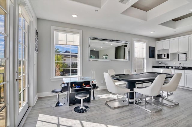 dining room featuring sink and light hardwood / wood-style flooring