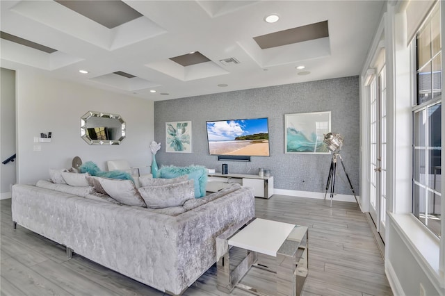 living room featuring coffered ceiling and light wood-type flooring