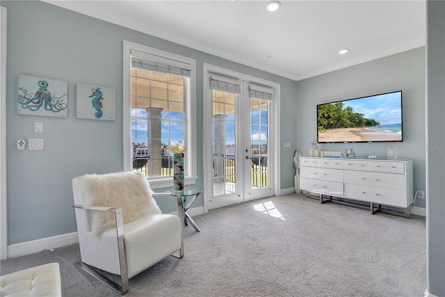 living area featuring crown molding, light colored carpet, and french doors