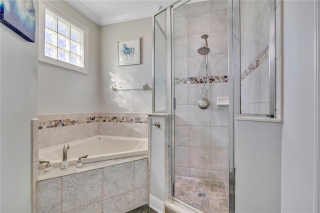 bathroom with ornamental molding and separate shower and tub