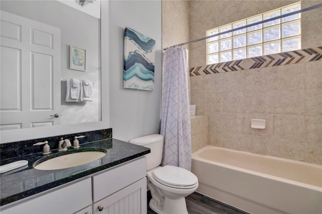 full bathroom featuring shower / bathtub combination with curtain, vanity, hardwood / wood-style flooring, and toilet