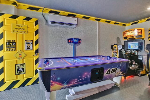 playroom featuring carpet flooring and an AC wall unit