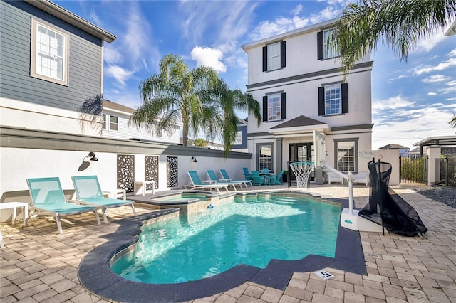 view of swimming pool with a patio and an in ground hot tub