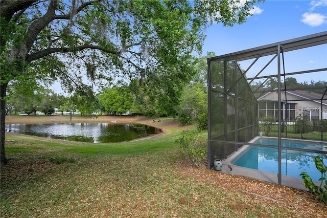 view of yard with a water view and a lanai