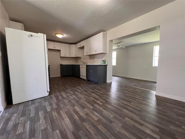 kitchen with white appliances, white cabinetry, ceiling fan, and dark hardwood / wood-style flooring