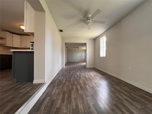 interior space with ceiling fan and dark hardwood / wood-style floors