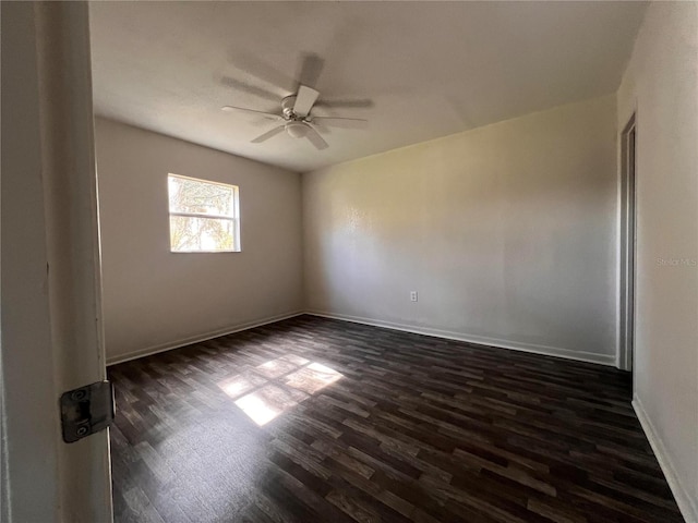 empty room featuring ceiling fan and dark hardwood / wood-style floors