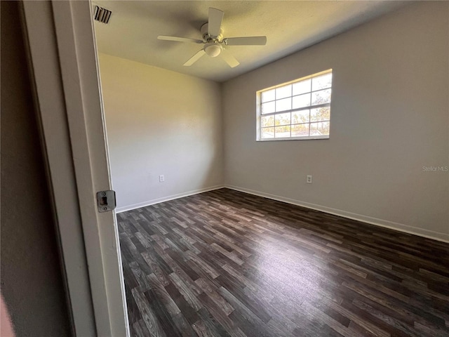 spare room featuring dark hardwood / wood-style floors and ceiling fan