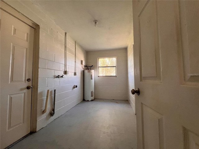 interior space featuring concrete flooring and water heater