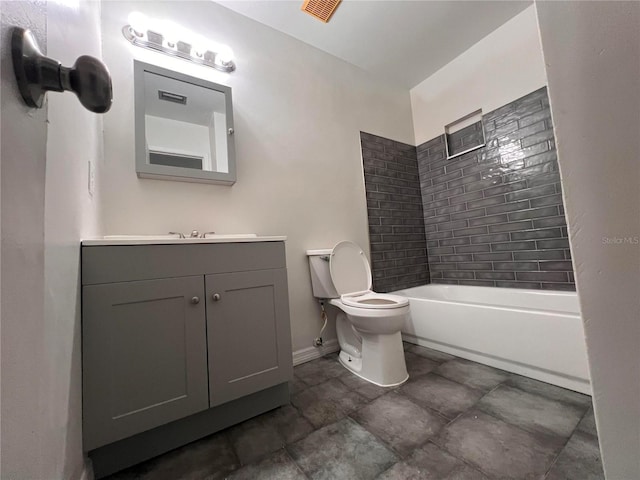 full bathroom featuring vanity, toilet, and tiled shower / bath combo