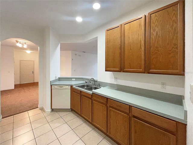 kitchen featuring sink, light tile patterned flooring, and white dishwasher