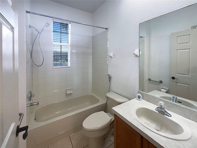 full bathroom with tile patterned floors, toilet, tiled shower / bath, and vanity