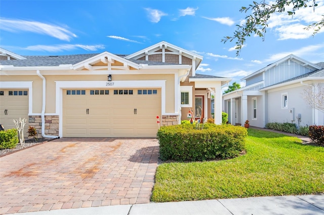 view of front of house featuring a garage and a front lawn