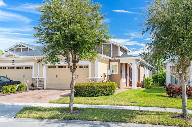 view of front of property with a garage and a front lawn