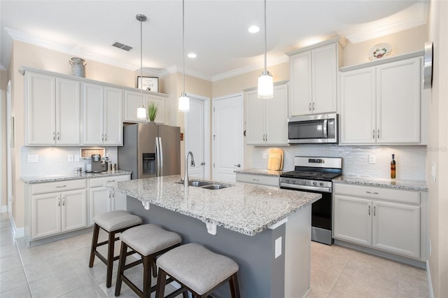 kitchen featuring white cabinetry, appliances with stainless steel finishes, sink, and hanging light fixtures