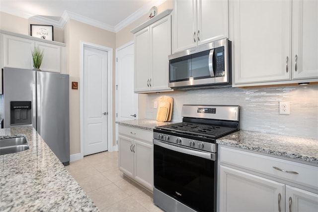 kitchen featuring white cabinetry, ornamental molding, stainless steel appliances, and light stone countertops