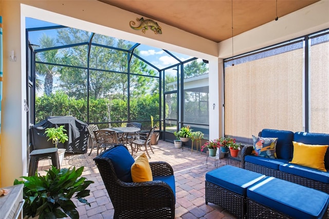 view of patio / terrace with an outdoor living space, a lanai, and a grill