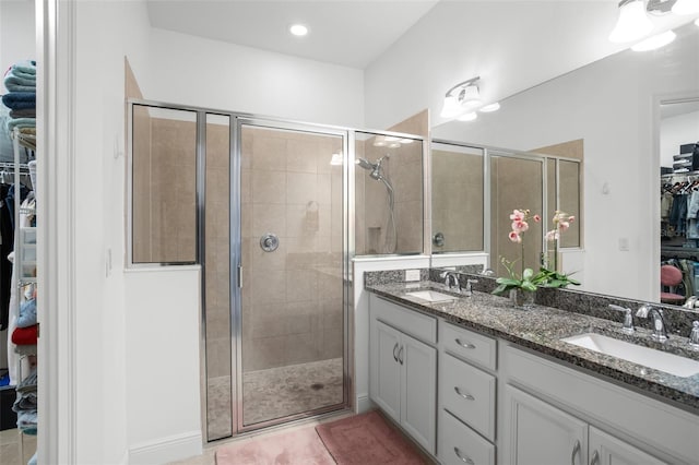 bathroom featuring vanity, tile patterned floors, and walk in shower