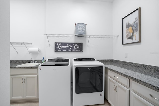 laundry room featuring cabinets, sink, and washing machine and dryer