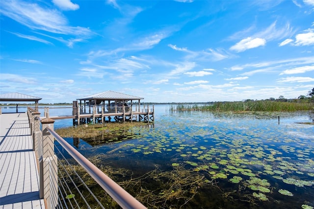 view of dock featuring a gazebo and a water view